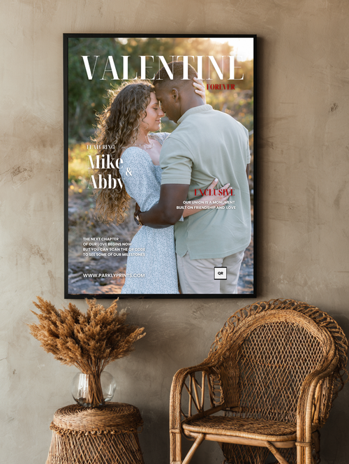 Framed magazine cover with a couple embracing, placed on a textured wall with a wicker chair and decorative plant.